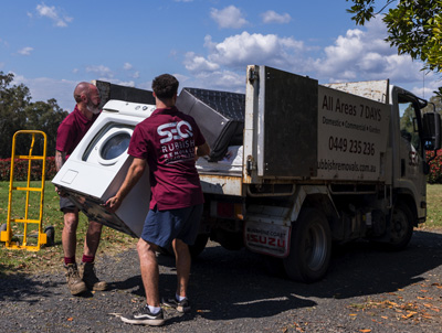 Rubbish removals whitegoods being loaded into truck